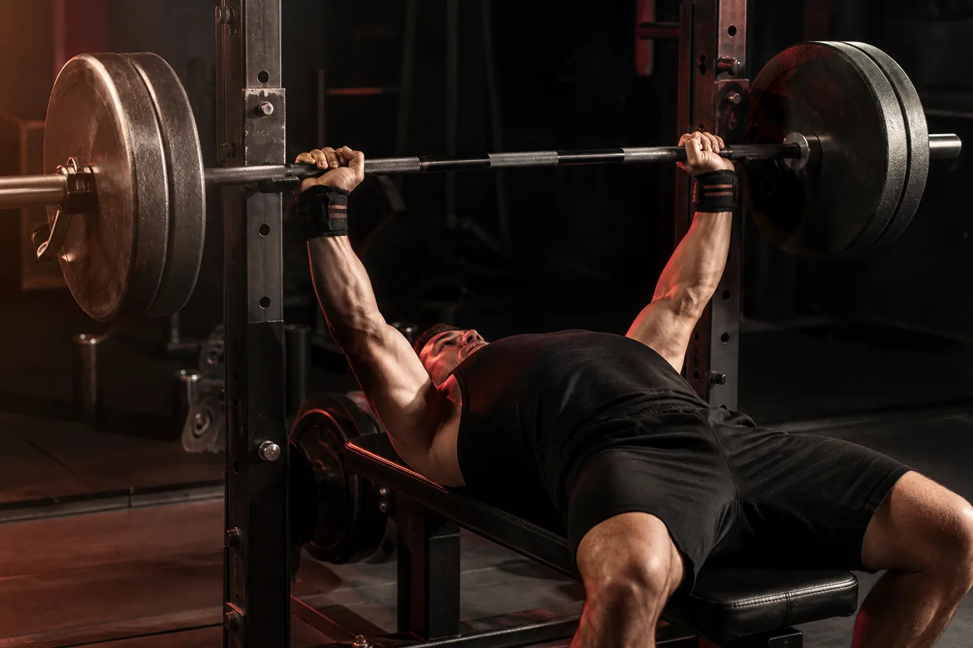 Athlete pressing a barbell on a flat bench